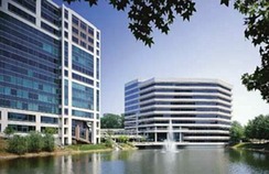 View of Lakeside Commons office complex with both Building Two (at left) and Building One (in background) with lake in foreground.