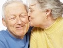 Mature grey-haired couple embracing.